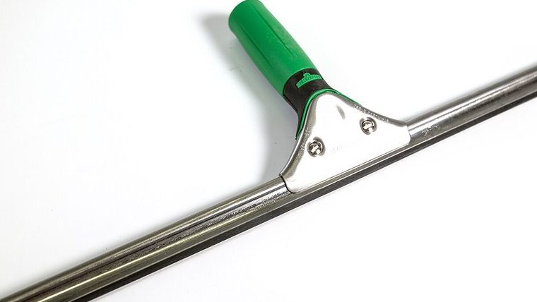 A professional window-cleaning squeegee with a green handle and a chrome head, laid on a plain white ground